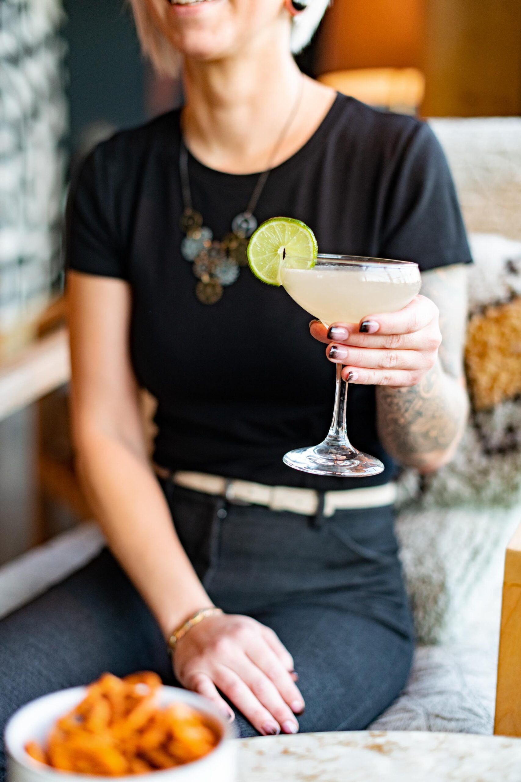 Woman holding out cocktail drink
